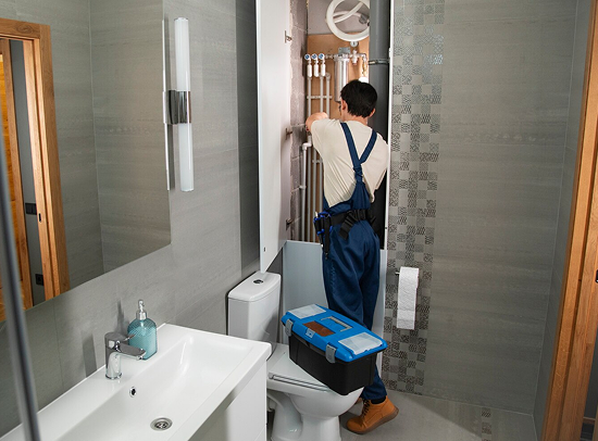plumber working in the bathroom